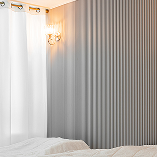 The three-dimensional depth of the accent wall meets subtle lighting to complete the wall interior.